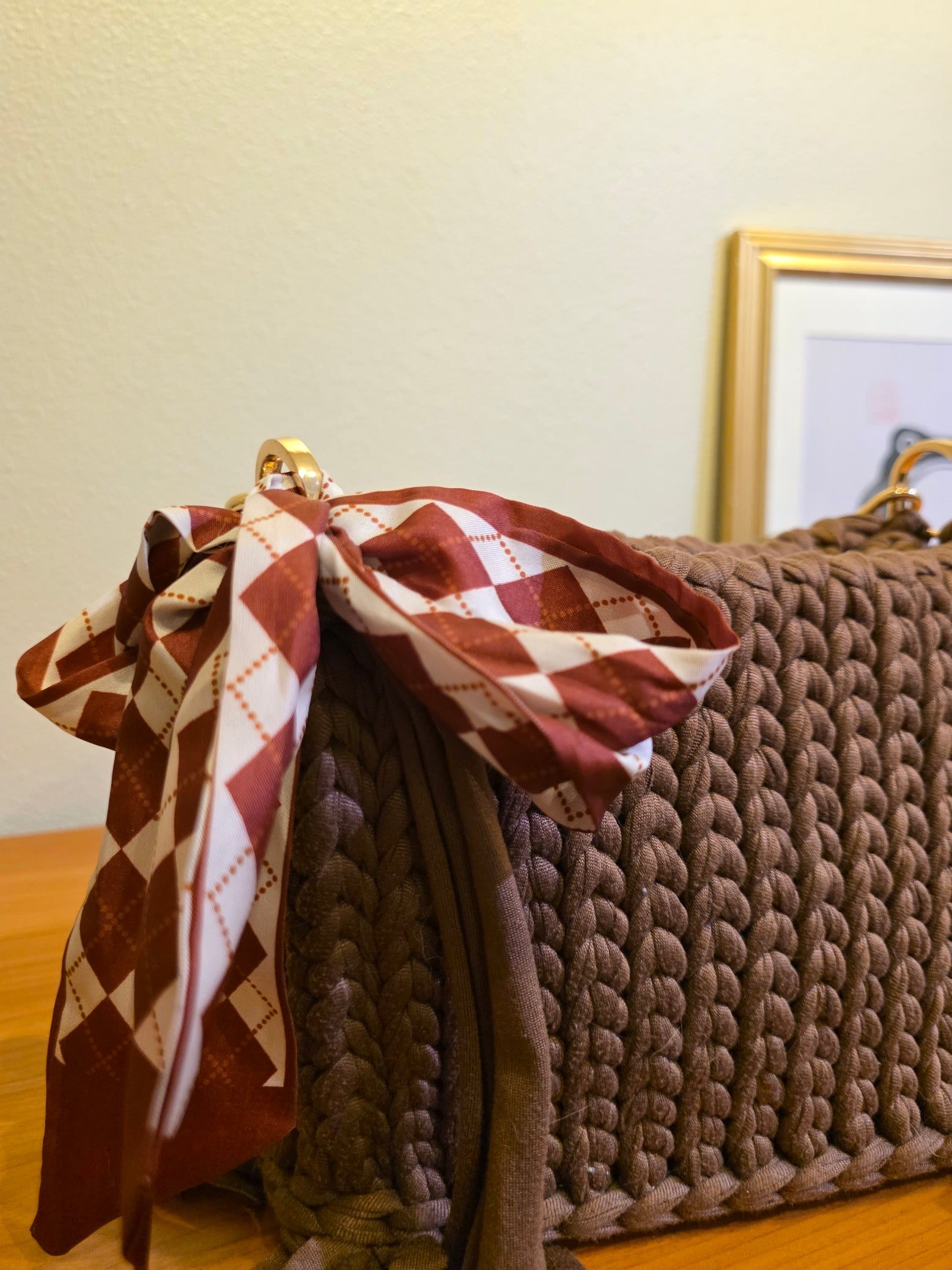Close up shot of a brown crochet handbag showing the detailed stitches